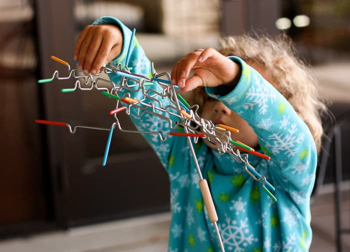 A young girl playing the game Suspend at a family game night.