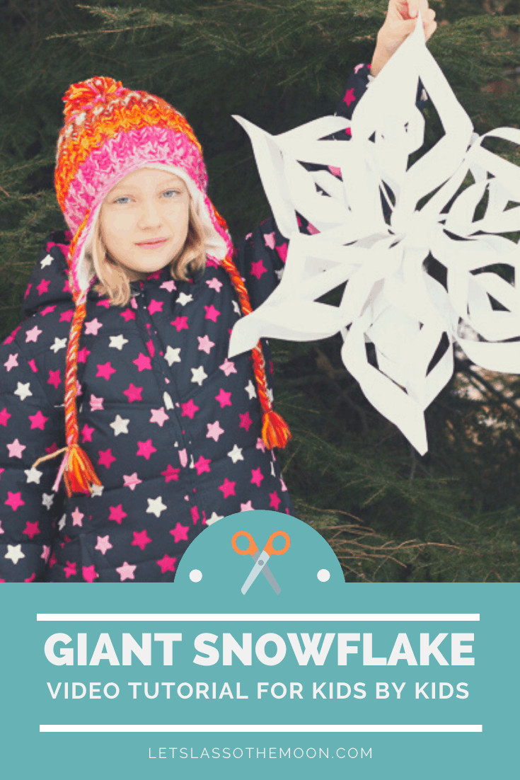 Child holding giant 3D snowflake