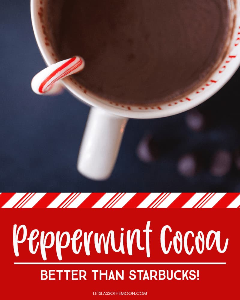A cup of homemade peppermint hot chocolate with a candy cane hanging over the cup