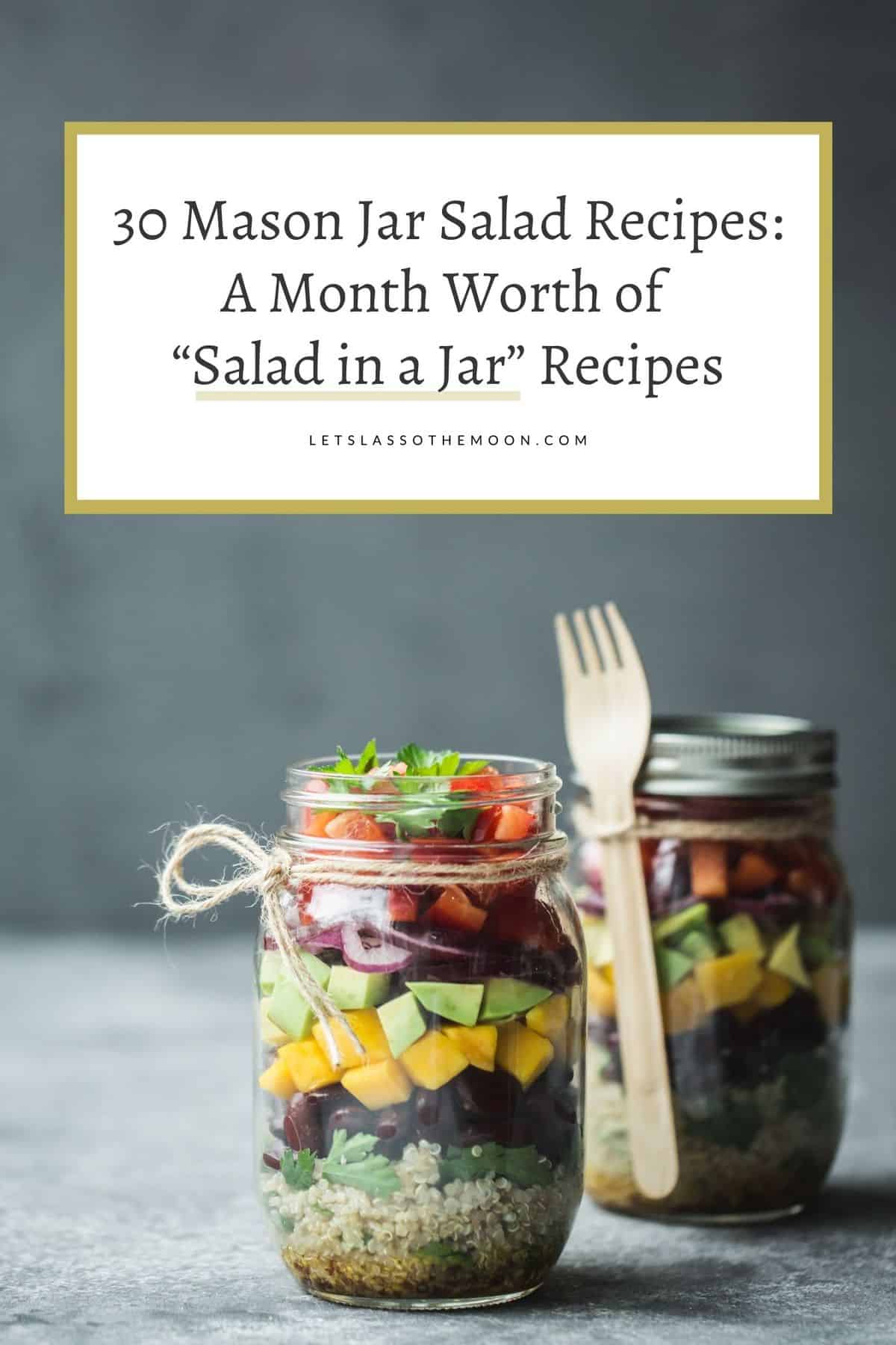 A mason jar filled with different layers of salad, vegetables, and a bamboo fork attached.
