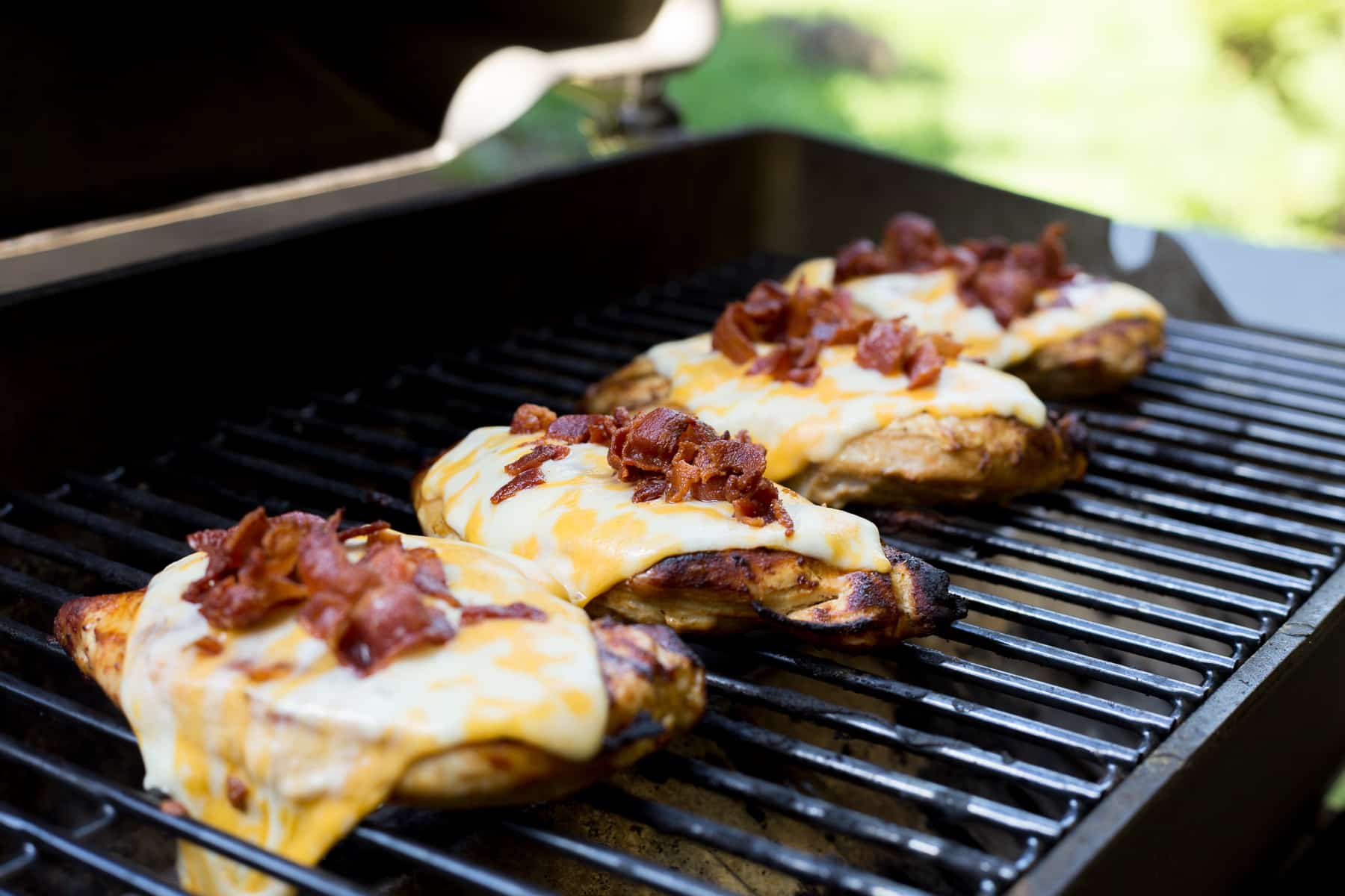 This easy-cheesy grilled Monterey Chicken recipe is THE BEST. BBQ sauce, cheese, and bacon make it a must-try summer cookout staple. *My kids and husband love this!