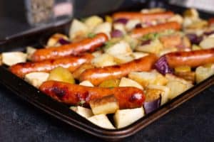 This oven-roasted sausage and potatoes bake is easy, simple, and delicious. Perfect for a school-night family dinner. Chicken sausage and apples give this classic a delicious fall spin. This one sheet-pan supper just happens to be gluten-free, dairy-free and paleo-friendly too. #dinner #recipe #onepotmeal *My kids love this recipe (minus the suggested dollop of mustard!!!!)