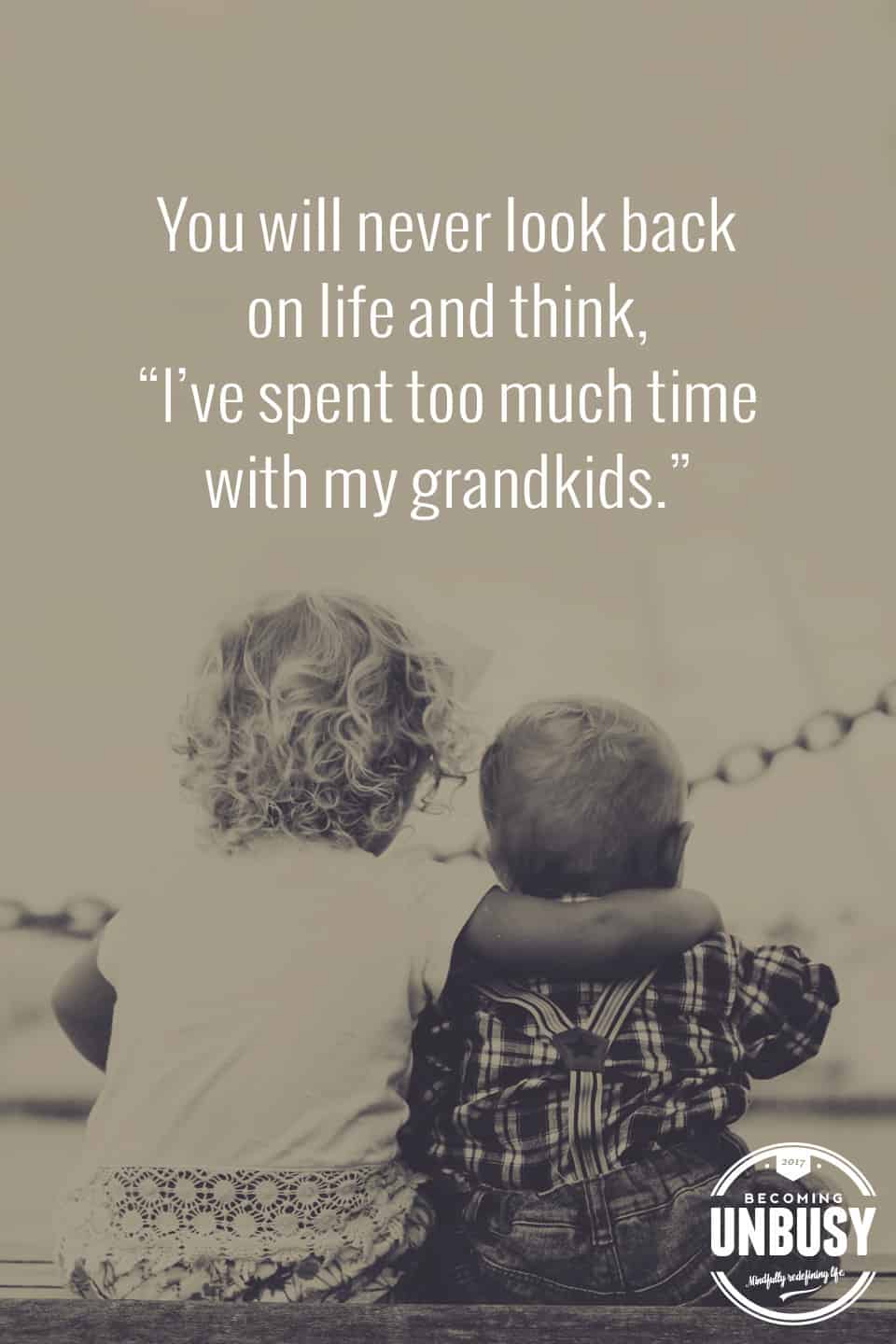 Two little kids sitting shoulder to shoulder with this quote above, "You will never look back on life and think, "I've spent too much time with my grandkids."You will never look back on life and think, "I've spent too much time with my grandkids."You will never look back on life and think, "I've spent too much time with my grandkids."You will never look back on life and think, 'I've spent too much time with my grandkids.'"