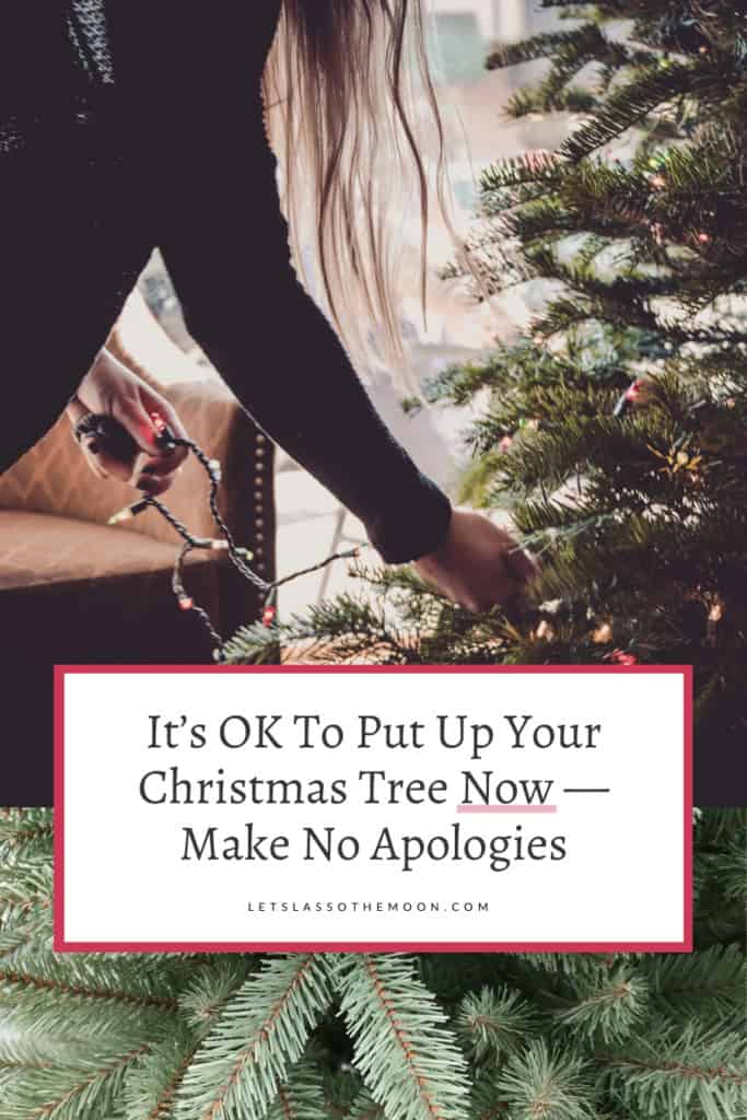 A woman stringing lights on a Christmas tree with an artilce headline written overtop which says, "It’s OK To Put Up Your Christmas Tree Now — Make No Apologies."