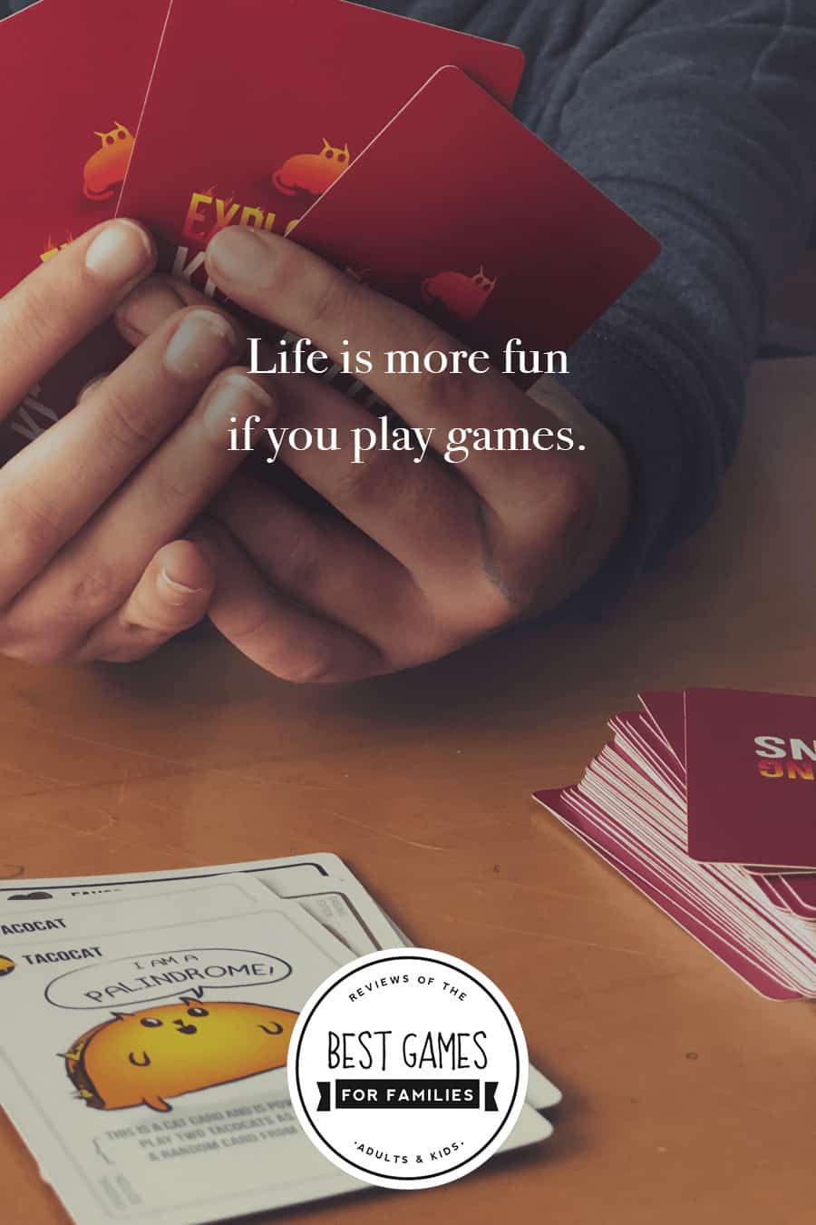 Young girl holding Exploding Kitten cards with the following quote written overtop, "Life is more fun if you play games."