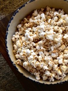 A bowl of popcorn covered in white chocolate.