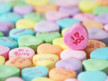 Valentine's Day candy hearts with one highlighted saying "I love you"