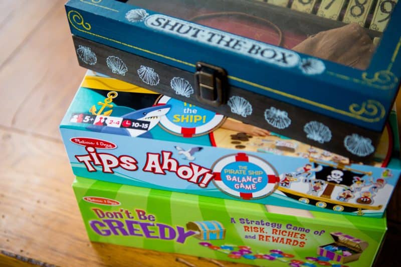 Stack of kid-friendly board games for family game night.